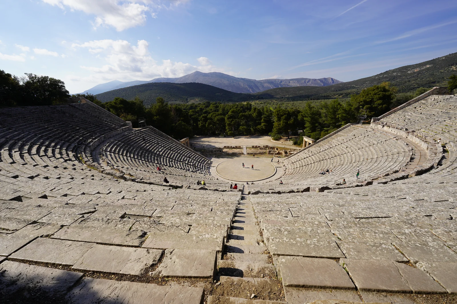 The ancient Theatre of Epidaurus in Greece, showing the perfectly preserved semicircular stone seating and orchestra.