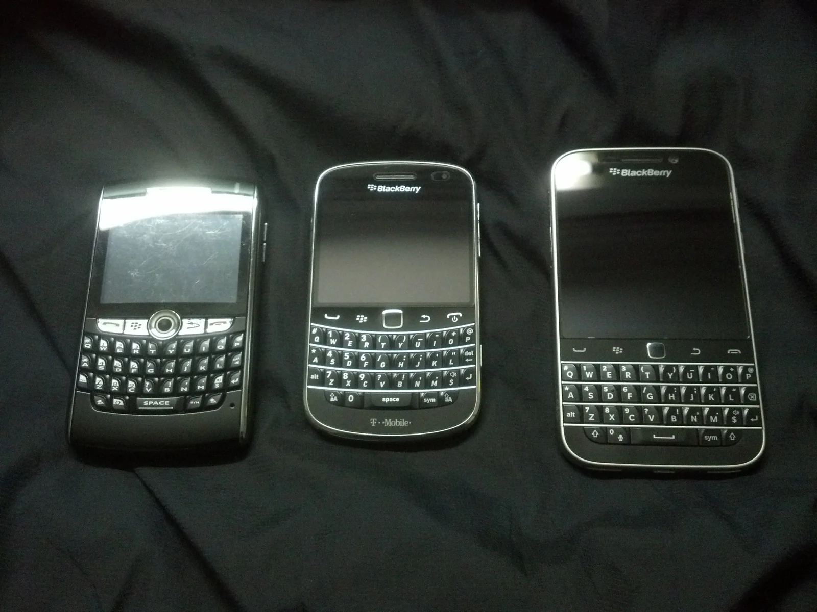 Three generations of BlackBerry devices showing the evolution from phone to smartphone.